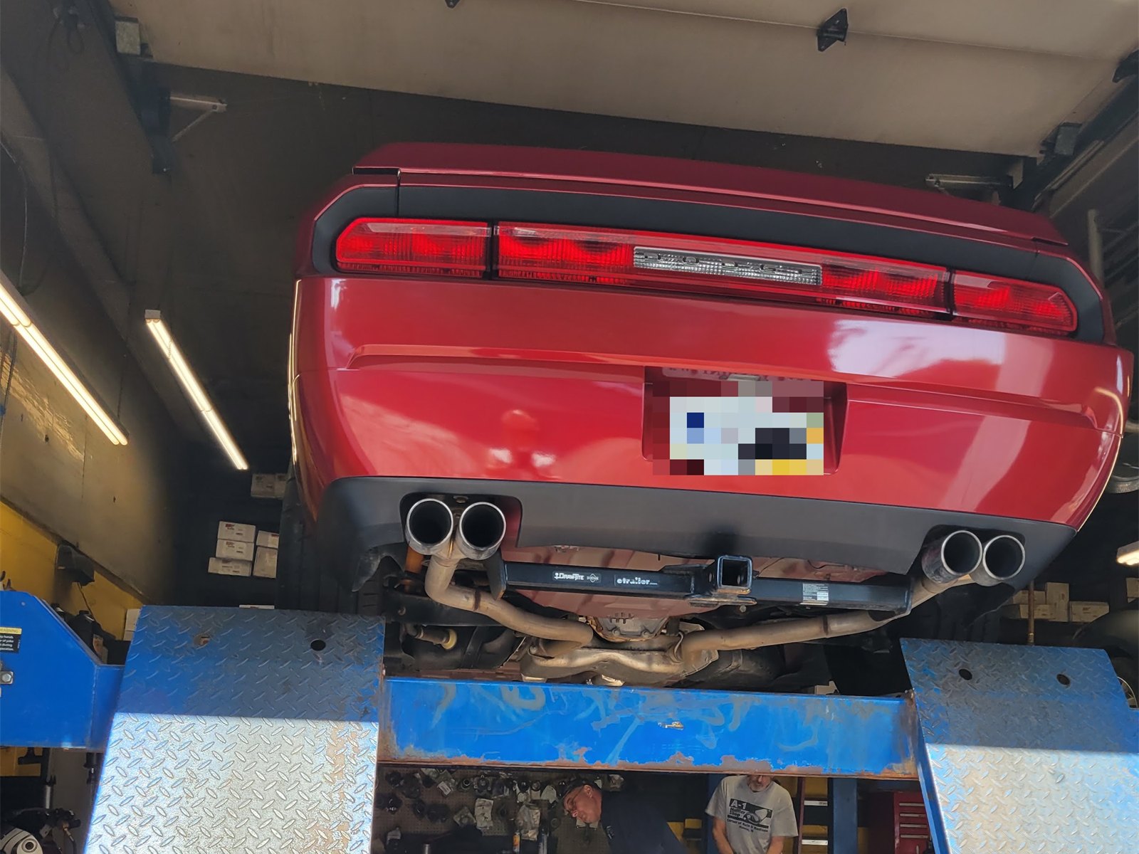 A car up on the lift for exhaust work at A-1 Muffler Shop