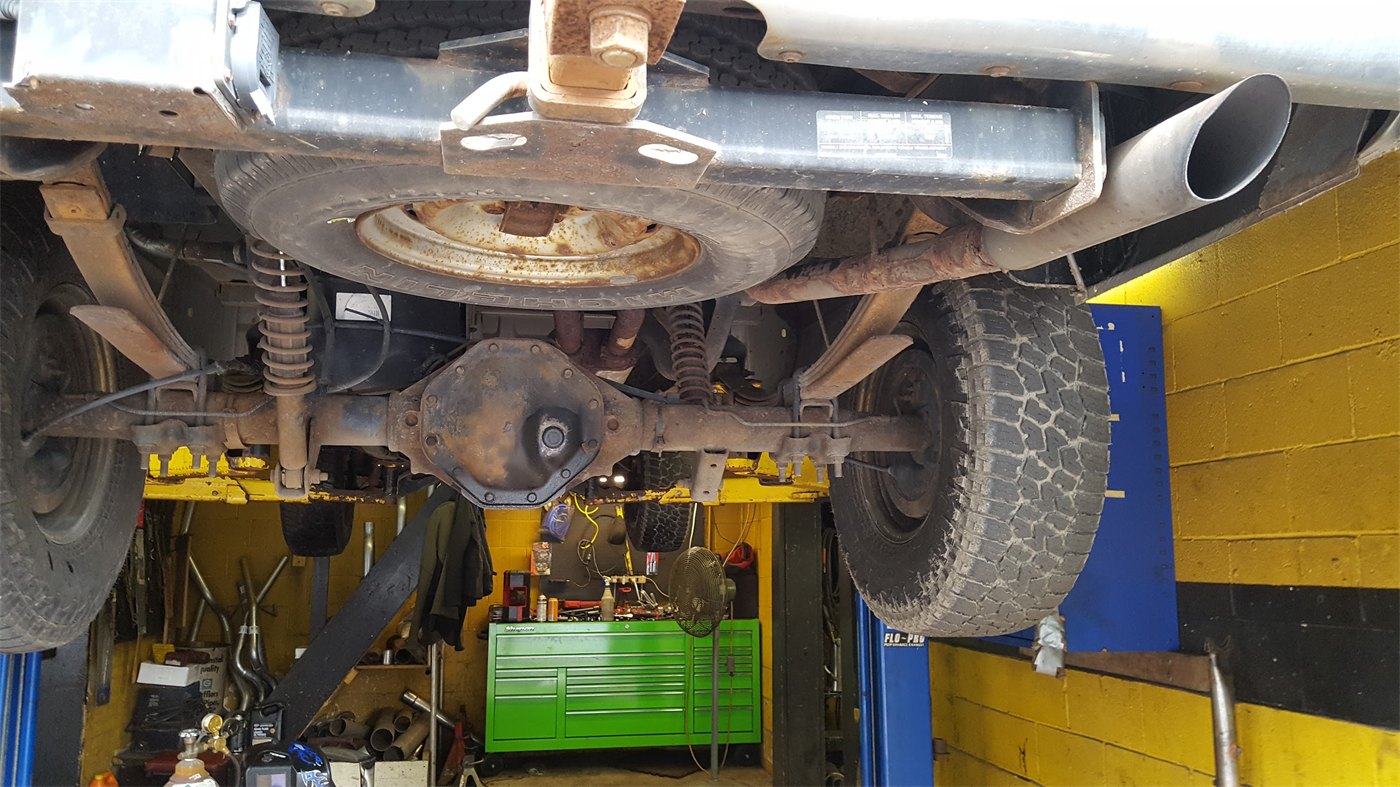 Underneath a truck on the lift at A-1 Muffler Shop