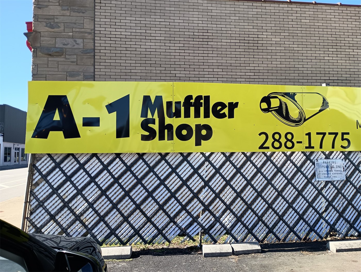 The yellow A-1 Muffler Shop sign